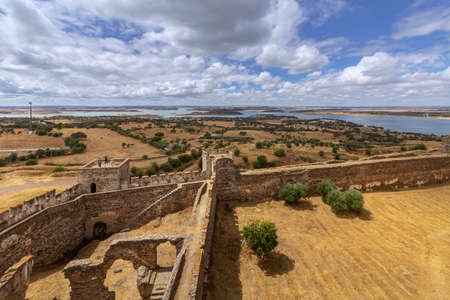 Mora medieval castle view, with Alentejo famous region tourist destination landscape in the background, Portugal.のeditorial素材