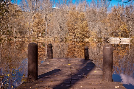 runway landing in a lake, in a sunny autumn day and calm water creating a very attractive mirror.の写真素材