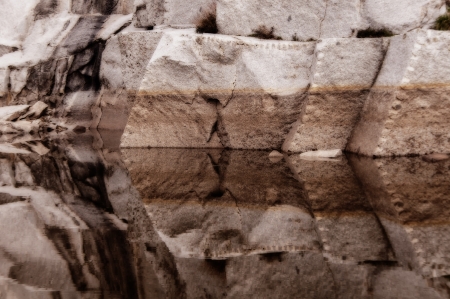 Quarry of granite flooded by a lake, creating an effect mirror of symmetrical formsの写真素材