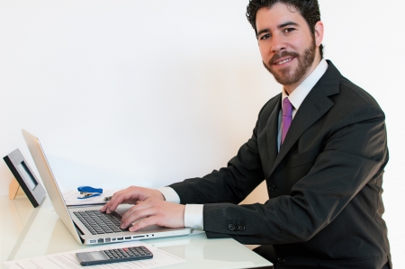 Businessman working at the computer satisfied with their workの写真素材