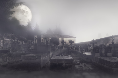 Foggy night and full moon in the cemetery の写真素材