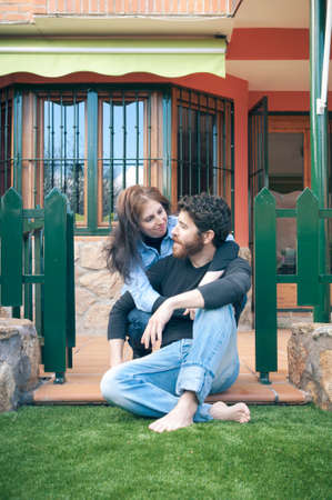 Young happy couple embracing in the garden at sunsetの写真素材
