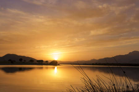 Reflections on the lake in a amazing sunsetの写真素材