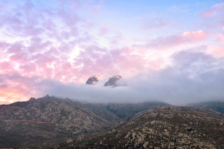 Sunset over the smoky clouds mountainの写真素材