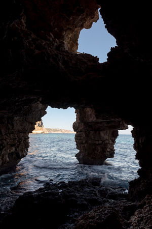 Cave of the Arches in the cove of Moraig in Valencia. Spain.の写真素材