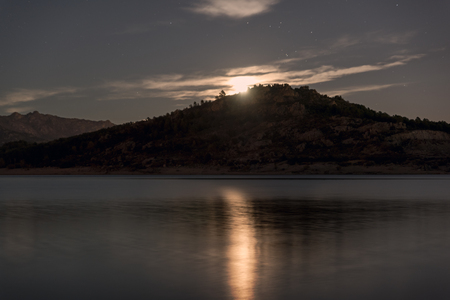 Night landscape view of full moon over lake.の写真素材