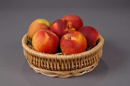 Fresh and colorful peaches on a neutral backgroundの写真素材