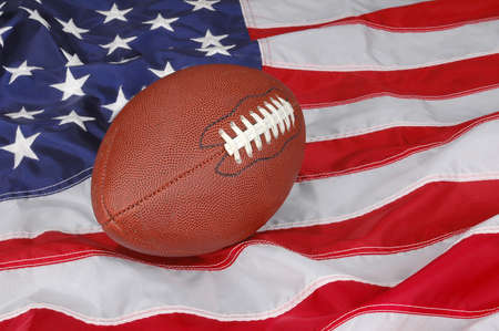 American Football with flag in backgroundの写真素材