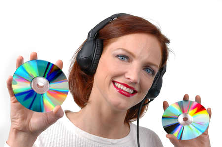 Woman with headphones holding CDs on white backgroundの写真素材