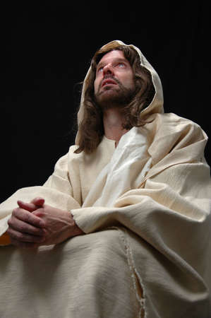 Jesus portrait in prayer with black backgroundの写真素材
