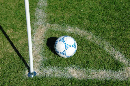 Soccer ball in the corner on a sunny day