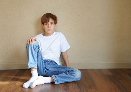 Boy seatting on the floorの写真素材