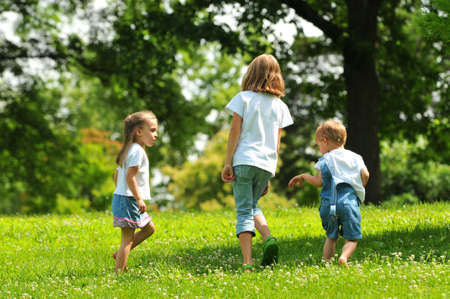 Children playind outdoors in the parkの写真素材