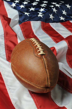 Football against an American flag on a vertical formatの写真素材