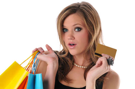 Young beautiful woman shopping with credit card in her hand isolated on white