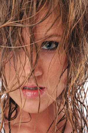 Young beautiful fashion woman with wet hair isolated on a white backgroundの写真素材