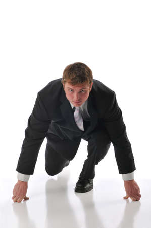 Businessman ready for a race isolated agains a white backgroundの写真素材