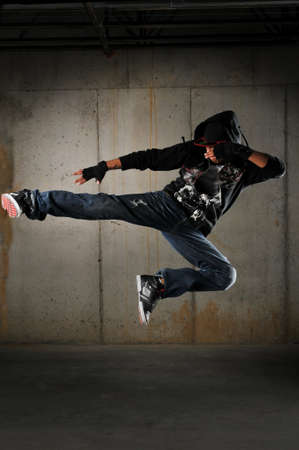 Hip hop dancer performing against a grunge wallの写真素材