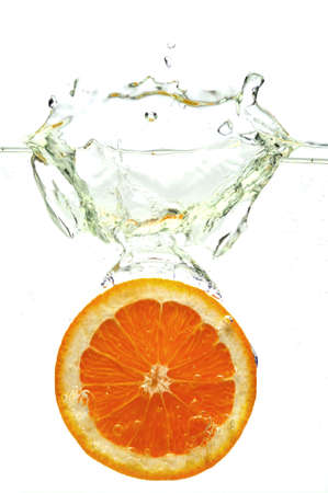 Orange dropped in water isolated on awhite backgroundの写真素材
