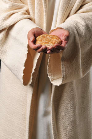 Jesus holding a bread as a symbol of bread of lifeの写真素材