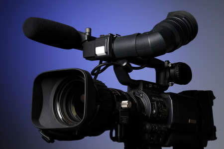 Professional video camera on a blue background