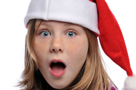 Titlle girl's portrait wearing a Santa's hat isolated on a white backgroundの写真素材
