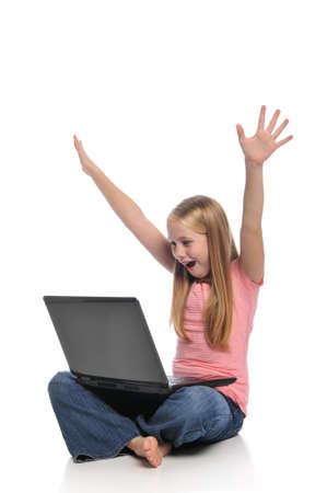 Young girl expressing excitement with laptop isolated on whiteの写真素材