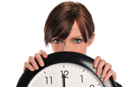 Businesswoman holding a clock isolated on a white backgroundの写真素材