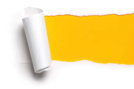 ripped white paper against a yellow backgroundの写真素材