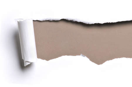 ripped white paper against a brown background ripped white paper against a brown background