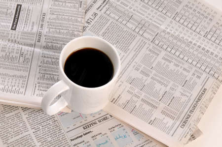 Businesspapers and cup of coffee isolated on a white backgroundの写真素材