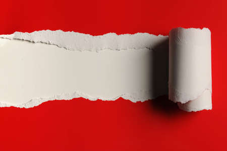 Rip red Paper and white bakground with space for textの写真素材