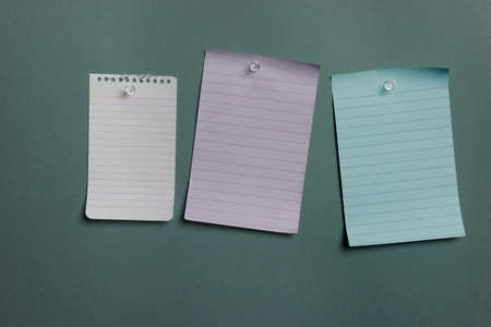 Three blank notes pined to a green boardの写真素材