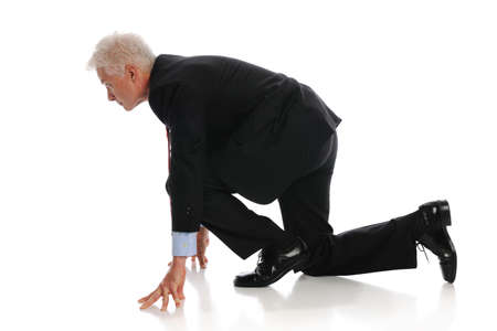 Businessman ready to start a race uisolated on a white backgroundの写真素材