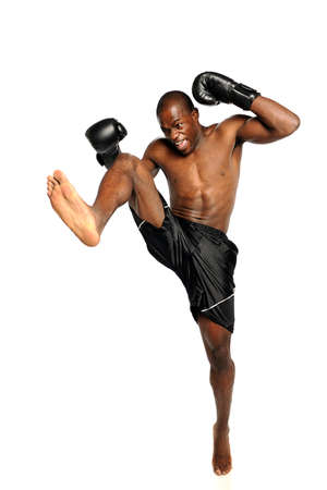 Extreme Fighting Athete kicking isolated on a white background
