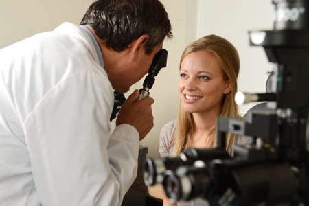 Eye Doctor with female patient during an examination at the office