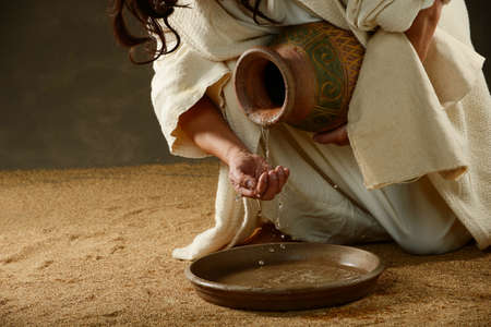 Jesus pouring water from a jug の写真素材