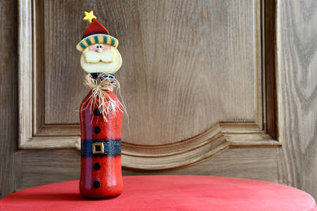 Christmas Ornament made from a bottle standing by the doorの写真素材