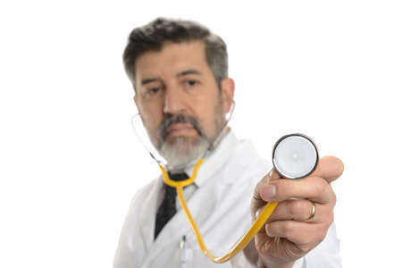 Doctor holdind a stethoscope with focus on the hand isolated on a white backgroundの写真素材