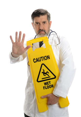 Mature Doctor with warning sign isolated on a awhite backgroundの写真素材