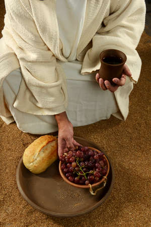 Jesus with bread wine and grapes on a vertical formatの写真素材