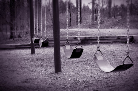 Some lonely empty swings.の写真素材