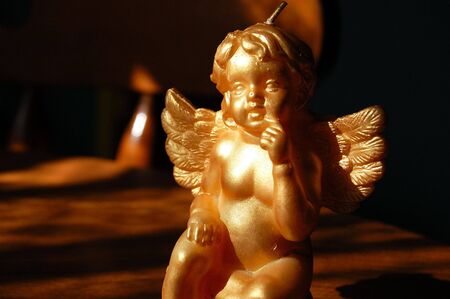 A golden cherub candle.の写真素材