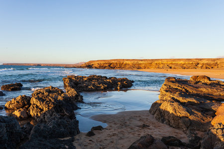 rocks in the foreground at playa de escarpes in Fuerteventura