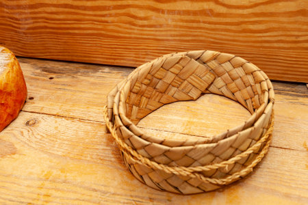Wicker basket on a wooden background. Basket for food.の写真素材