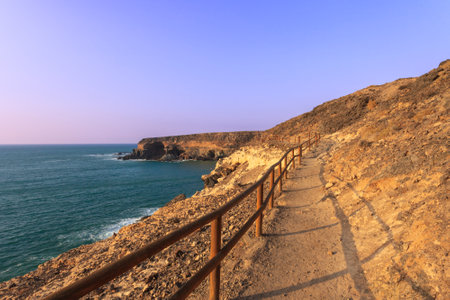Hiking trail leading to the sea at sunset, Fuerteventura, Canary Islands