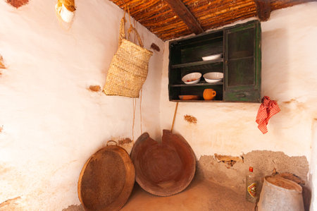 Old rustic kitchen with wooden utensils in an old houseの写真素材