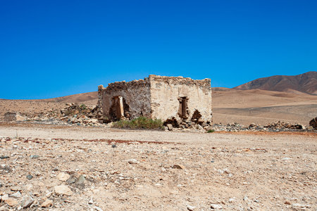 Ruins of an old house in the middle of the desert.の写真素材