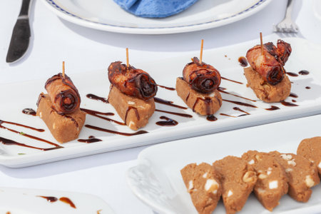 canape with gofio and sauce on a white plate, closeupの写真素材