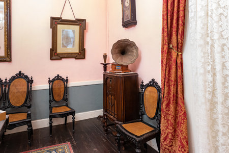 Interior of a room with an old gramophone and two chairs